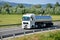 White MAN truck coupled with tank semi-trailer drived on slovak D1 highway in countryside.