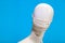 White Mannequin With White Mask Blue Background