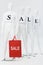 White mannequins with sale lettering on papers and shopping bag