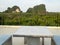 White marble bench table desk and marble chair on roof top with mountain hill and green natural mangrove view