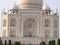White marble mausoleum facade with four minarets and large domes. Taj Mahal