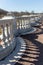 White marble railings in the garden, stone stairs, long shadows.