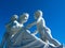 White marble statue. Mother with two children against blue sky. Los Angeles.