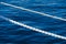 White marine mooring rope against background of blue water of Black Sea. Two white nautical cord. Background image