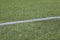 White marking strip on a football field with green