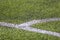 White marking strip on a football field with green
