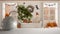 White mat table shelf with round marble vase and potted bonsai, green leaves, over Halloween autumnal living room with fireplace,