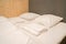 White mattress and comfortable pillows in hotel double bedroom for couple honeymoon