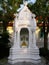 White mausoleum with Buddha image of the Thai royal family in the Royal Cemetery of Wat Ratchabophit temple in Bangkok