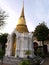 White mausoleum with door and golden stupa of the Thai royal family in the Royal Cemetery of Wat Ratchabophit temple in Bangkok