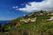 White mediterranean houses on a steep hillside surrounded by banana plantations.