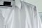 White men`s shirt on a hanger close up