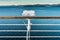 White metal exterior light fixture on railing of cruise ship, Alaska Inside Passage route.