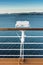 White metal exterior light fixture on railing of cruise ship, Alaska Inside Passage route.