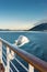 White metal exterior light fixture on railing of cruise ship, Alaska Inside Passage route.