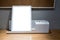 White metal notepad stand and stationery holder on glossy wooden