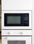 White microwave oven in modern scandi kitchen