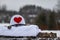 White military helmet with big red heart. It`s winter.