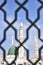 White minaret of the Prophet\\\'s Mosque through the bars in the city of Medina
