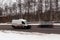 white minibus on a winter road. Motion blur