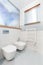 White minimalist bathroom with toilet and bidet