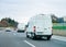 White Minivans on road van transport logistics