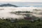 White Mist early Morning sunrise over the hill and Bungalow during rainy season