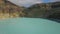 White mist hovers over the turquoise surface of the volcanic lake Kootainuamuri. Kelimutu tri coloured volcano crater