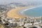 White modern architecture surrounding amazingly wide sandy beach in Agadir, Morocco