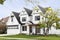 A white modern farmhouse with black roof and windows.