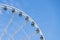 White modern ferris wheel  with blue sky background