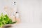 White modern kitchen decor with beige natural wooden dish, utensils, fresh green salad on wood background.