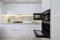 White modern kitchen with a stove, oven and microwave