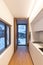 White modern kitchen with windows of view of nature and snow