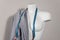 White modern mannequin or dressmakers dummy with gray fabric and hanging measuring tape