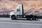 White modern semi truck reefer trailer on green summer highway