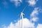 White modern windmill. With blue sky and white clouds. Dutch sky.