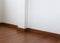 White mortar wall and wood floor