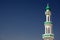 White mosque with minaret against blue sky