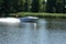 The white motorboat rushes quickly on the lake