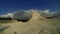 White mountain with lime clouds in timelapse