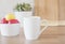 White Mug Mockup - Easter Theme. Easter Eggs. Colorful Eggs In Red And Yellow,  Close Up. Kitchenware In Modern Kitchen Interior