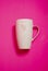 White mug with pink heart on the vivid pink backround
