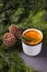 White mulled wine with various spices on a grey background with fir tree ande cones. Hot alcoholic beverage, winter and fall