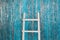 White New Year`s ladder. white ladder with new year`s decorations, blue new year background