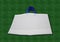 White non woven Fabric Shopping Bag with blue handle on Green Grass Background