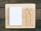 The white note book and wooden board on old deep brown planks