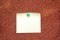 White note on cork board for message, pending information