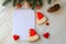 White notebook for Christmas wishes, goals, recipes for the New Year 2021 among tree, gingerbread cookies in form of Santa Claus