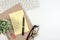 White office desk table with office equipment book, yellow paper note, keyboard and pencil with copy space.